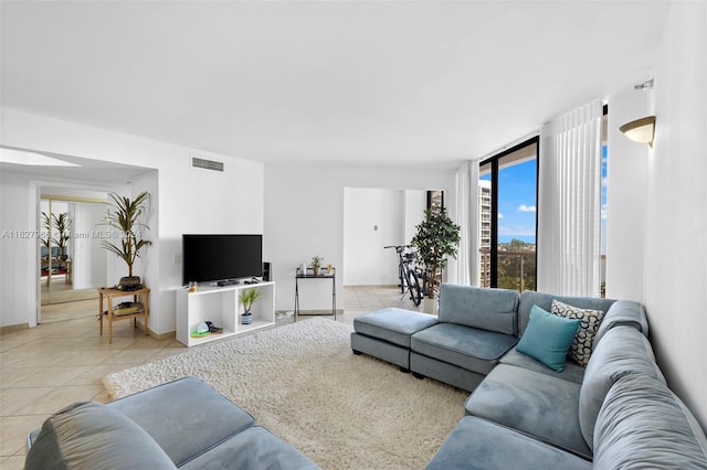 tiled living room featuring expansive windows