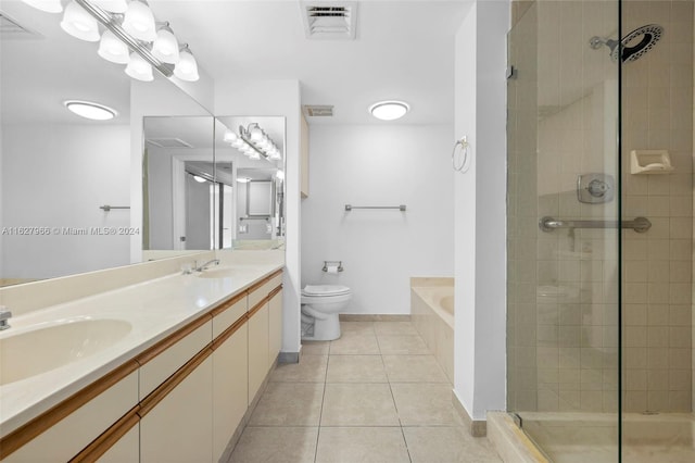 full bathroom featuring double vanity, shower with separate bathtub, tile patterned floors, and toilet