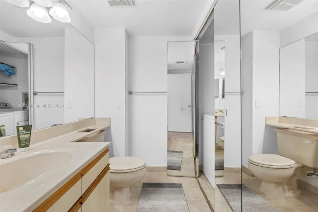 bathroom with tile patterned flooring, toilet, and vanity