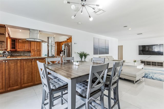 dining room with light tile patterned flooring and a chandelier