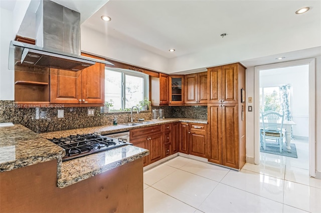 kitchen with tasteful backsplash, sink, a wealth of natural light, and ventilation hood