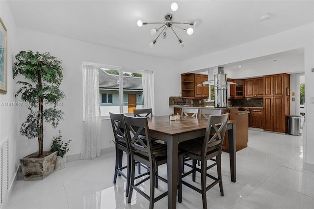 dining room featuring a chandelier and light tile patterned floors