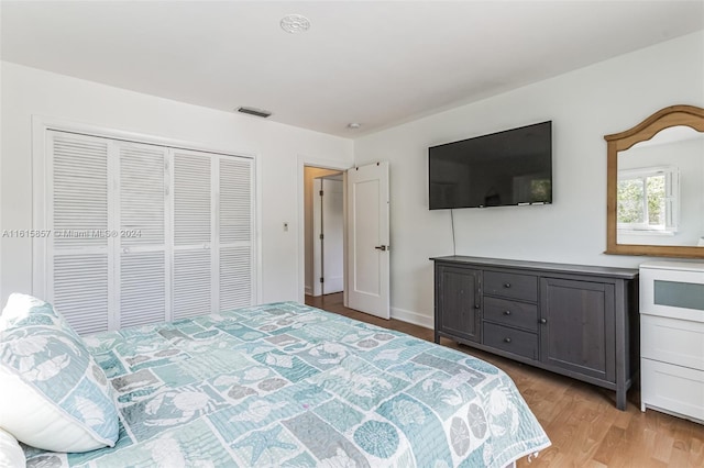 bedroom with light hardwood / wood-style flooring and a closet