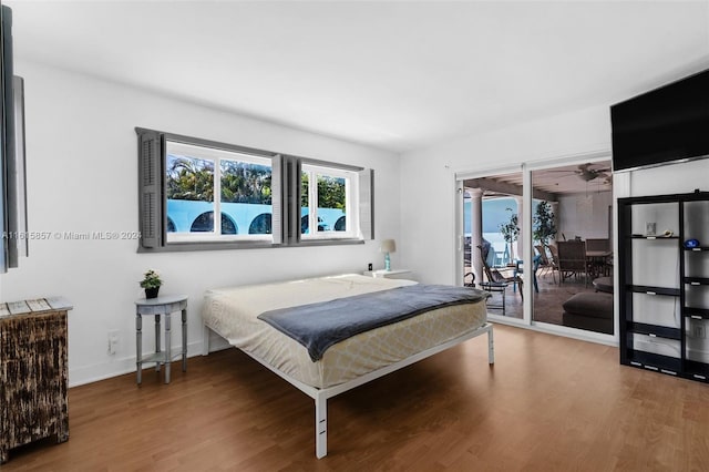 bedroom featuring access to outside and wood-type flooring