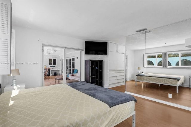 bedroom featuring hardwood / wood-style flooring and access to exterior