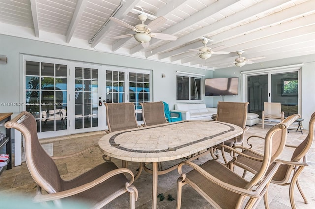 sunroom / solarium with beam ceiling, french doors, and ceiling fan