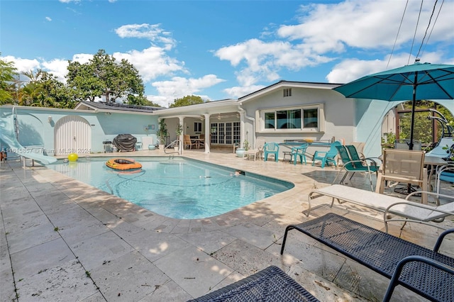 view of swimming pool featuring a patio area