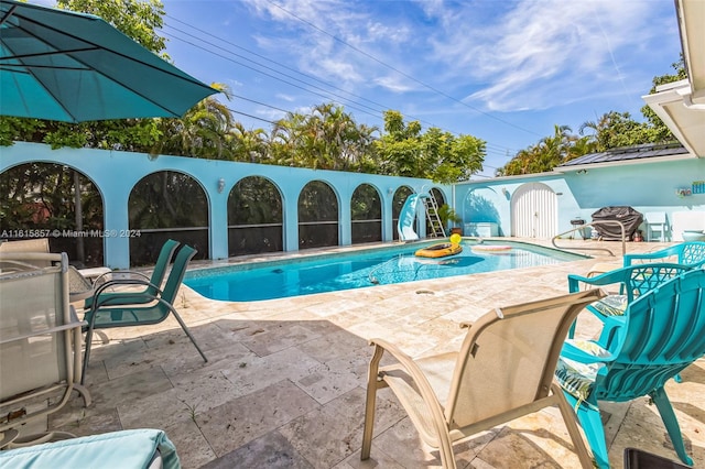 view of swimming pool featuring a patio area