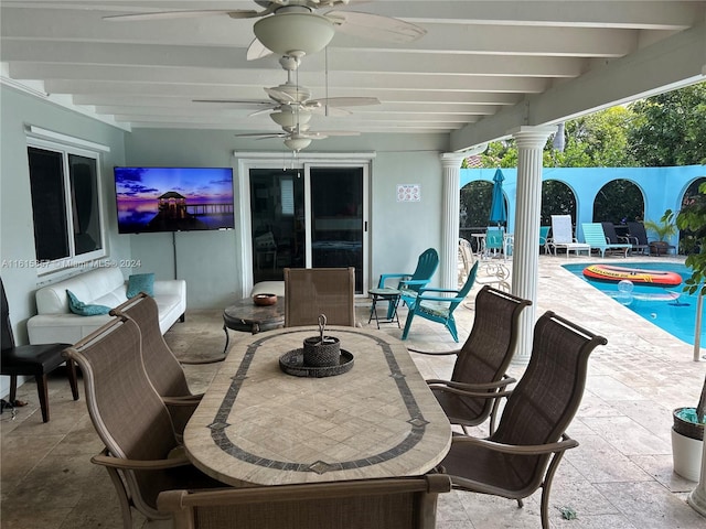 view of patio with a swimming pool and ceiling fan