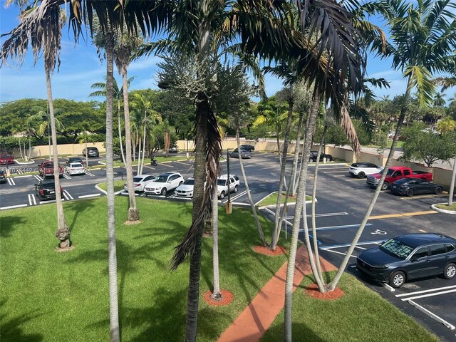 view of vehicle parking featuring a lawn