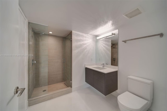 bathroom with vanity, walk in shower, and toilet