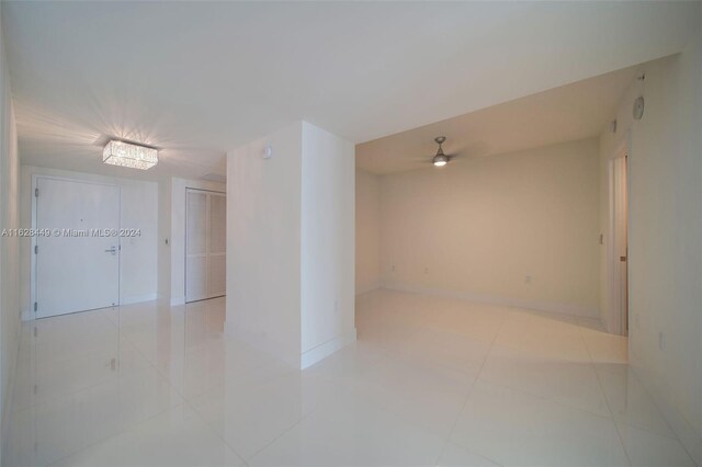 tiled spare room featuring ceiling fan