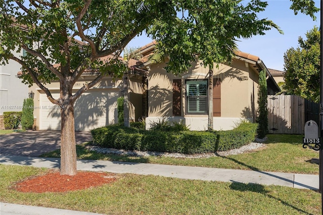 view of front of house with a garage and a front lawn