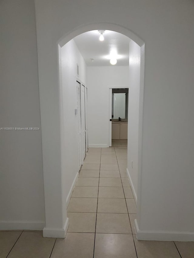 corridor with light tile patterned floors