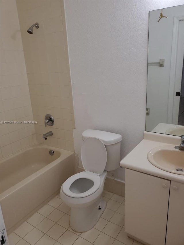 full bathroom featuring vanity, tile patterned flooring, tiled shower / bath combo, and toilet