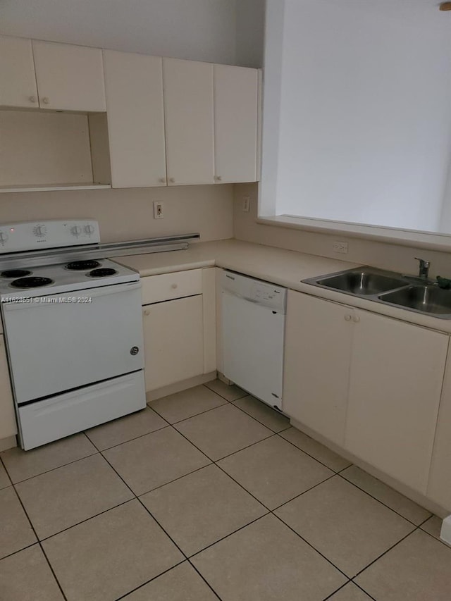 kitchen featuring sink, white cabinetry, light tile patterned floors, and white appliances