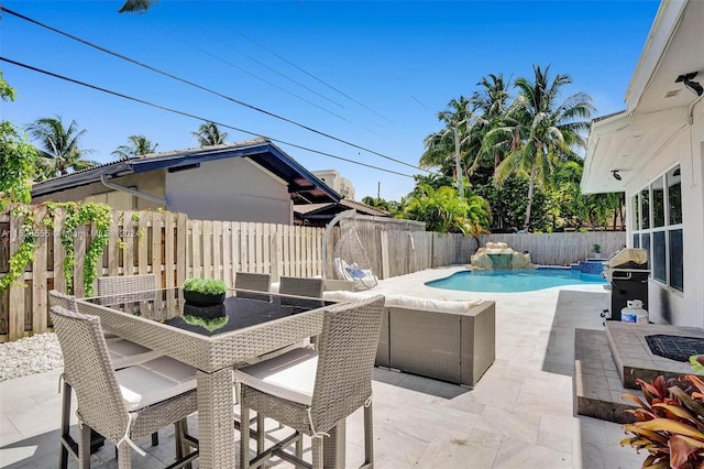 view of patio / terrace featuring a fenced in pool and a grill