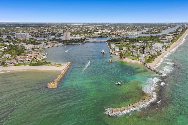 birds eye view of property featuring a water view and a beach view