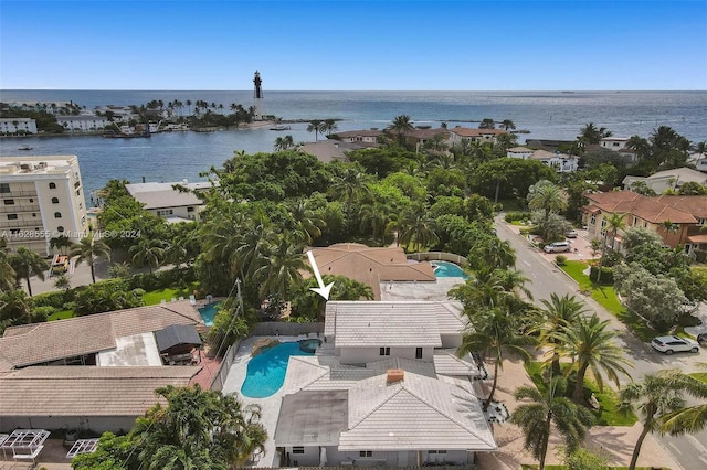 birds eye view of property with a water view