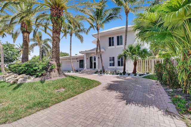 view of front of home with a garage and a front yard