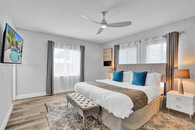 bedroom with light wood-type flooring and ceiling fan