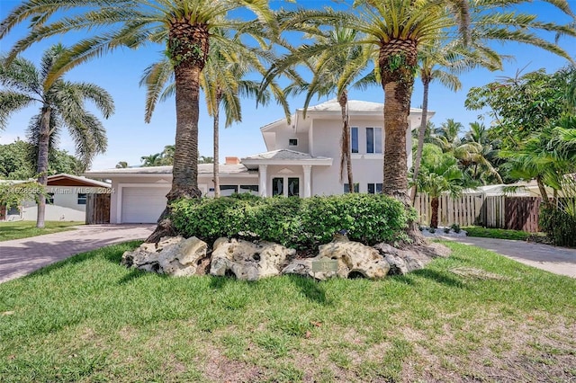 mediterranean / spanish-style house featuring a garage and a front yard