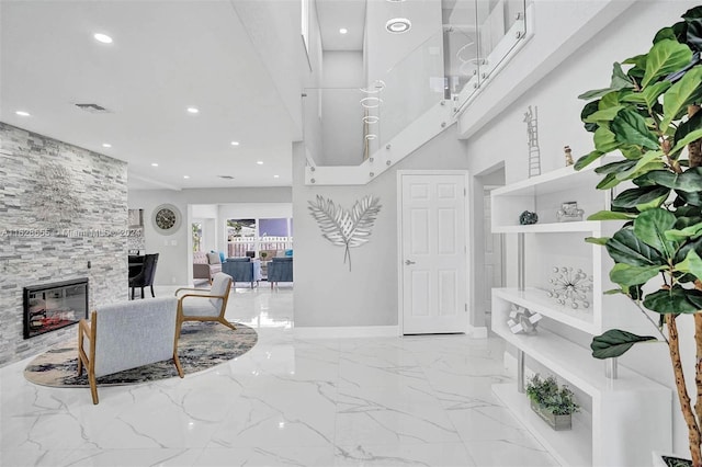 entryway with a stone fireplace