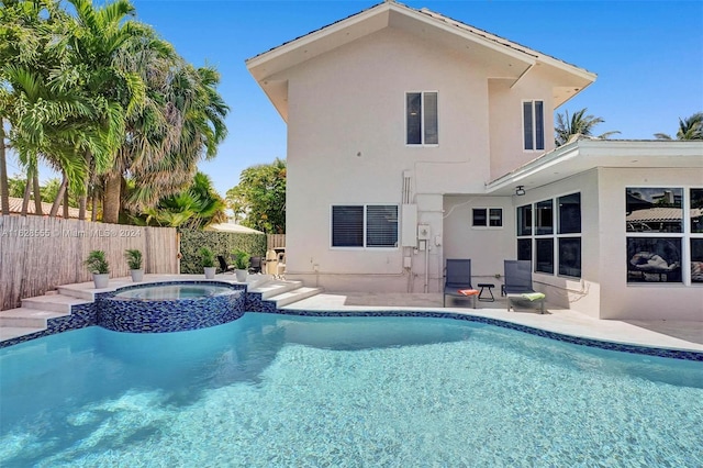 view of swimming pool with an in ground hot tub and a patio area