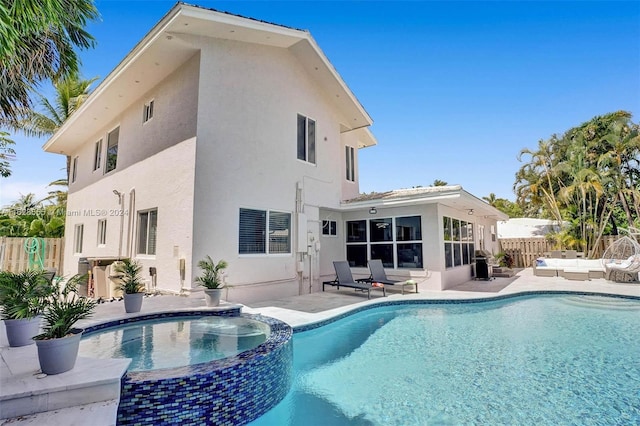 view of swimming pool with an in ground hot tub and a patio