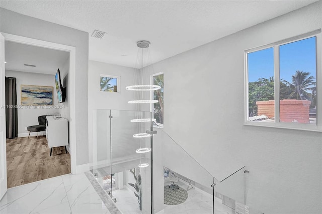 bathroom featuring a textured ceiling and an enclosed shower