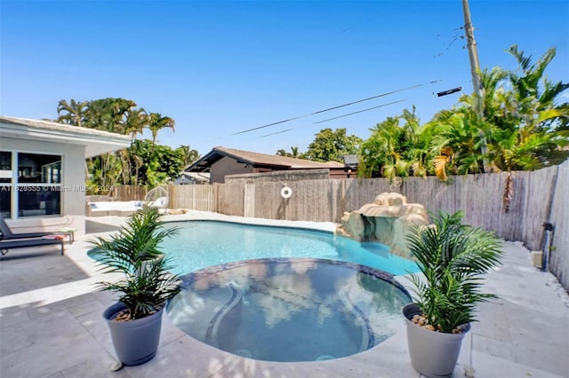 view of swimming pool with an in ground hot tub and a patio