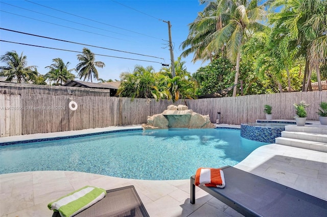 view of swimming pool with an in ground hot tub and a patio