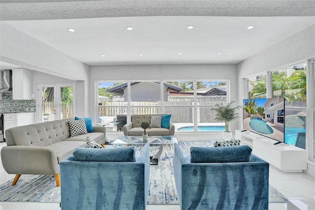 living room with a healthy amount of sunlight and french doors