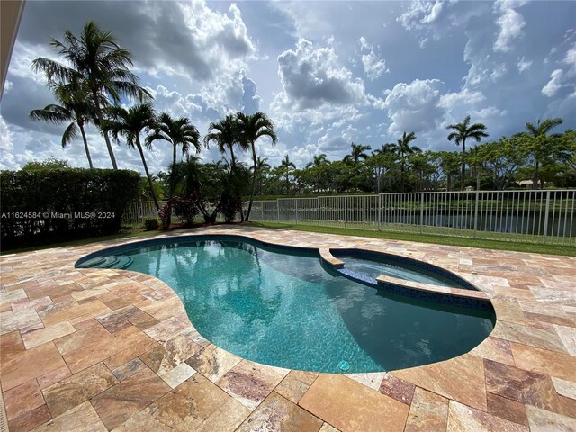 view of swimming pool with a patio and an in ground hot tub