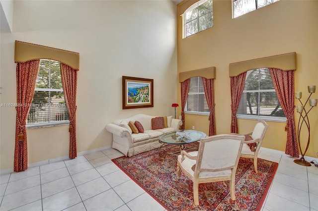 tiled living room with a towering ceiling