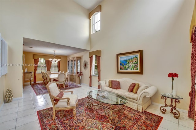 tiled living room featuring a chandelier and a high ceiling