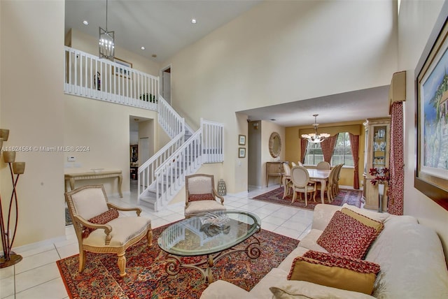 tiled living room featuring a towering ceiling and an inviting chandelier