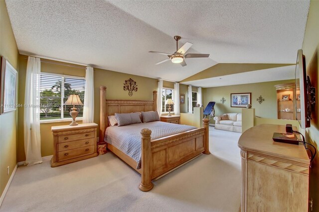 carpeted bedroom featuring a textured ceiling, ceiling fan, and lofted ceiling