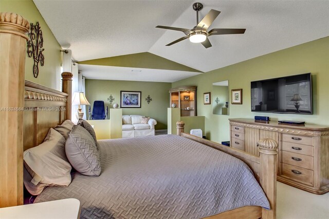 carpeted bedroom with a textured ceiling, ceiling fan, and vaulted ceiling