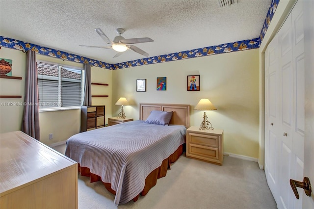 bedroom with light carpet, a closet, and a textured ceiling