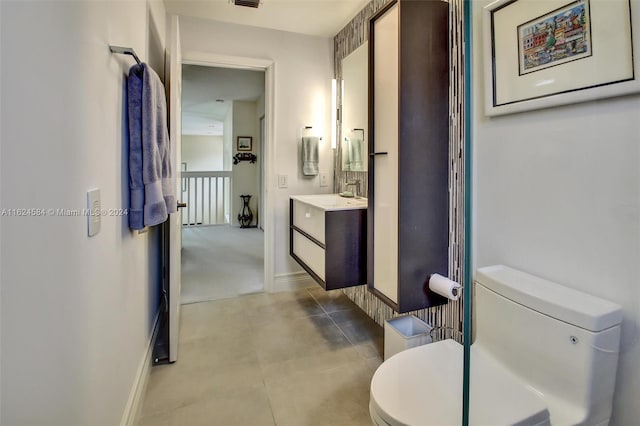 bathroom with tile patterned floors, toilet, and vanity