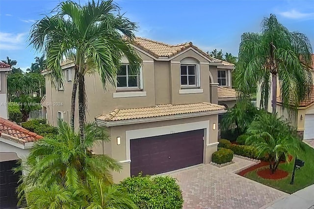 mediterranean / spanish-style house with a garage