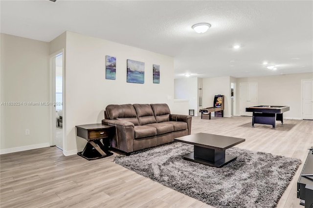 living room featuring light hardwood / wood-style flooring and pool table