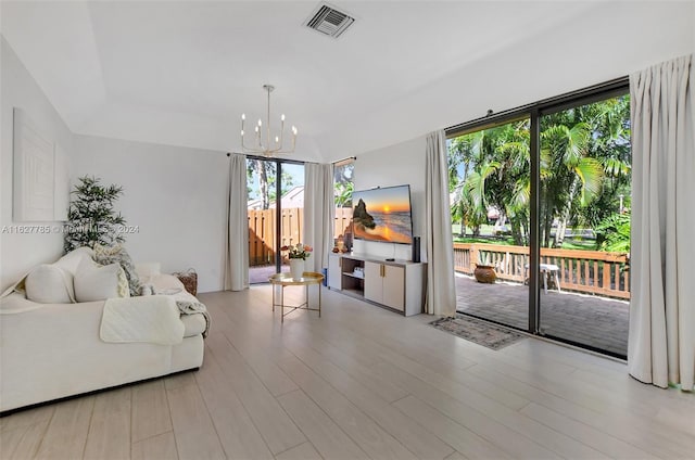 living room featuring an inviting chandelier and light wood-type flooring