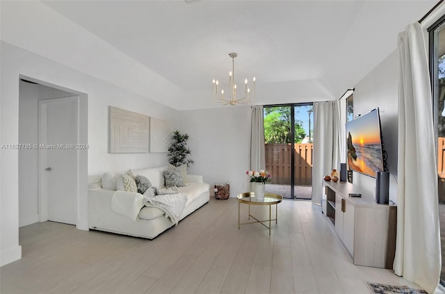 living room featuring a chandelier and light hardwood / wood-style floors