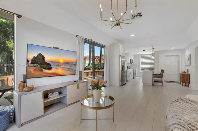 living room featuring a notable chandelier and light hardwood / wood-style flooring