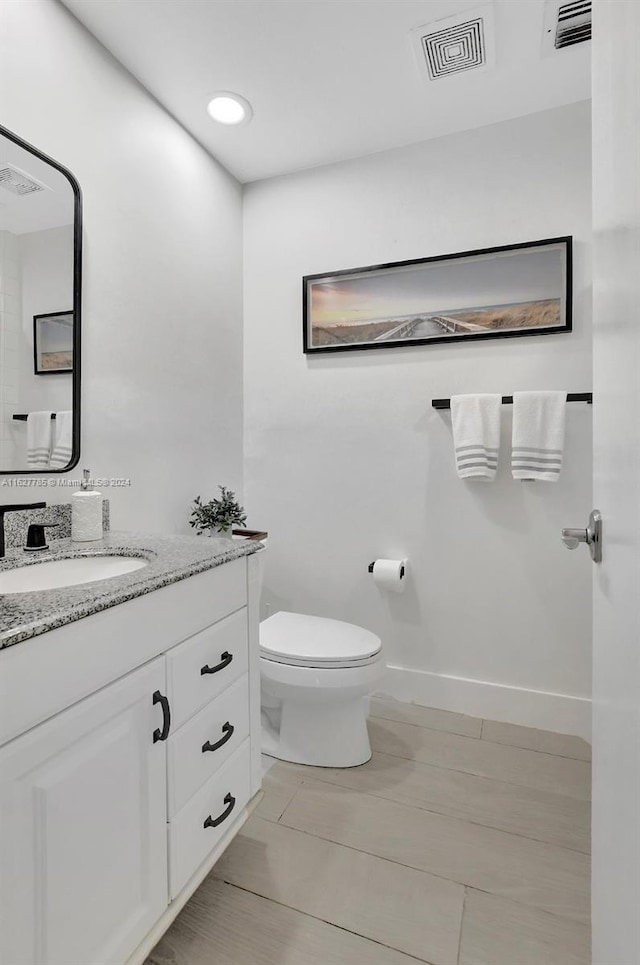 bathroom featuring vanity and toilet