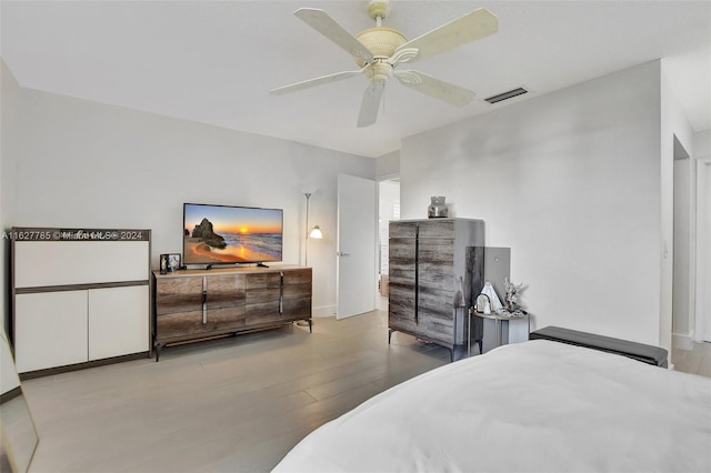 bedroom with light hardwood / wood-style flooring and ceiling fan