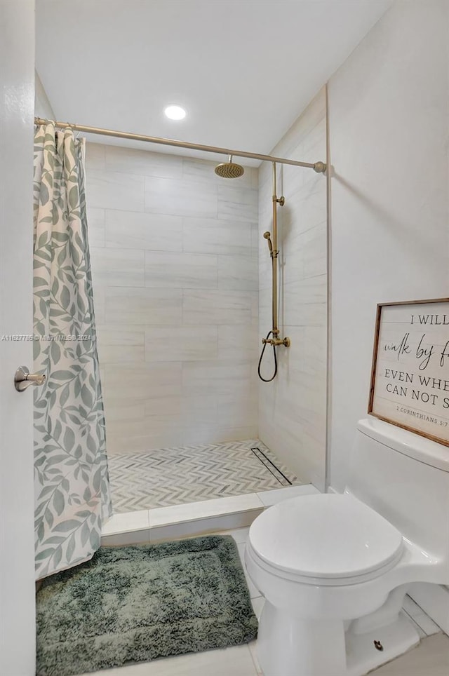 bathroom featuring toilet and walk in shower