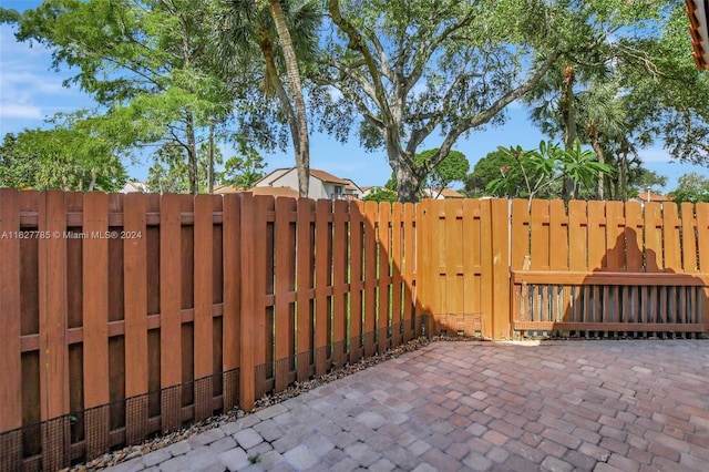 view of gate with a patio area